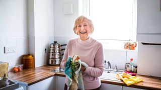smiling person drying hands on towel in kitchen.jpg