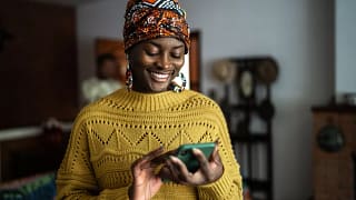 smiling person looking at smartphone.jpg