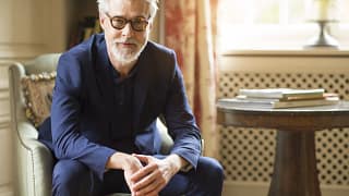 getty beard sitting serious expression blue shirt.jpg