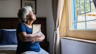 mourning loved one holding picture frame.jpg