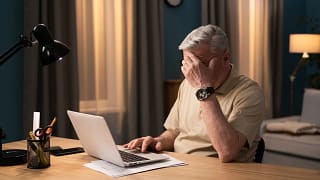 older man laptop covering face gettyimages .jpg