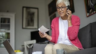 senior holding check and talking on phone.jpg