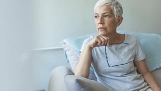 senior woman worried holding eyeglasses gettyimages .jpg