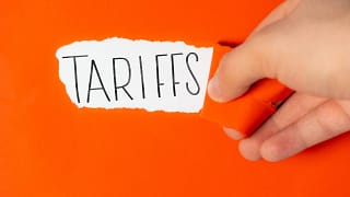 tariffs on torn orange paper.jpg