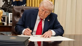 white house president donald trump signing executive order at resolute desk in oval office.jpg