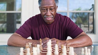 getty older man playing chess strategy moves winning.jpg