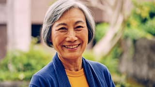 getty smiling happy outdoors blue sweater.jpg
