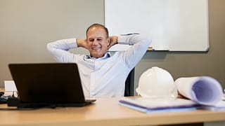 man s desk smiling gettyimages .jpg