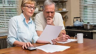 senior couple documents worried gettyimages .jpg