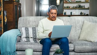 senior man laptop couch gettyimages .jpg
