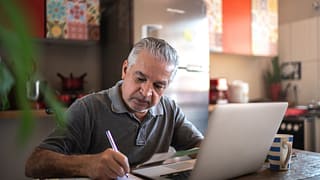 senior man laptop taking notes gettyimages .jpg