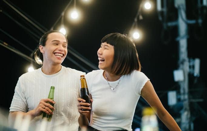 man and woman drinking beer on rooftop FlmiMS.width .jpg