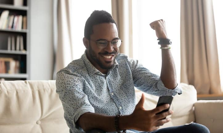 happy man with phone pumping fist dWwY.width