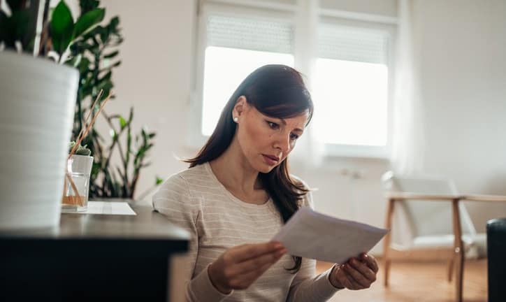 worried woman reading letter.width .jpg