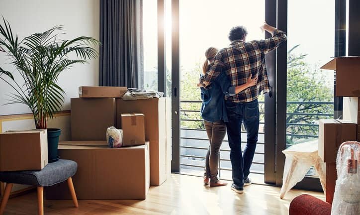couple at window with moving boxes in new hom.width VeumdPo.jpg
