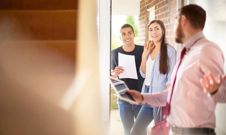 couple with realtor entering house cYeeLe.width .jpg