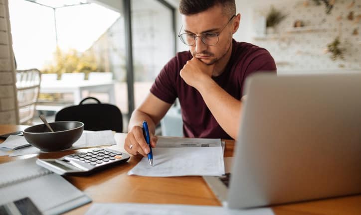 stressed man with bills and laptop.width .jpg