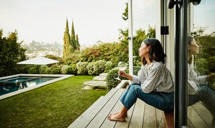 woman in backyard of house KrlPrb.width .jpg