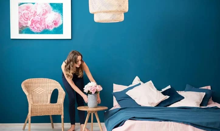 woman decorating bedroom.width .jpg