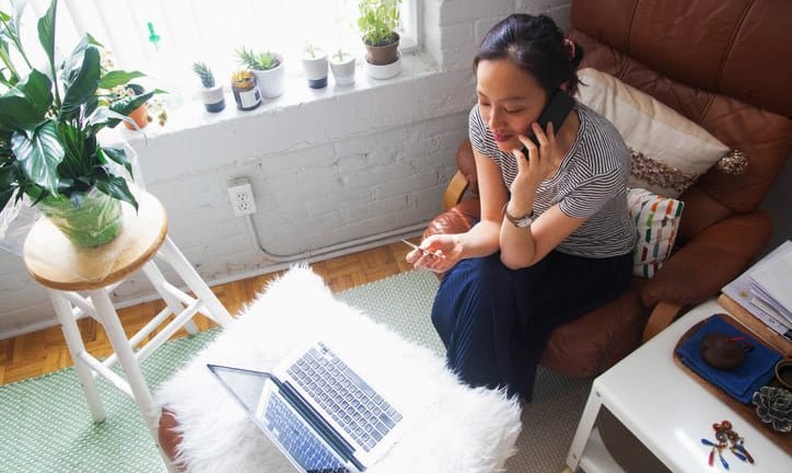 woman on phone with credit card and laptop y.width .jpg