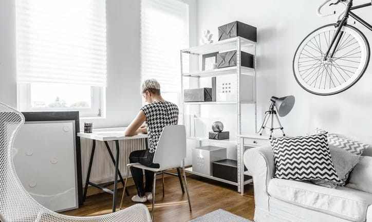 young woman at desk in small apartment.width .jpg