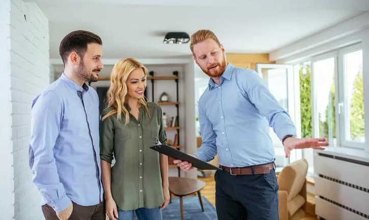 couple looking at house with realtor.width .jpg