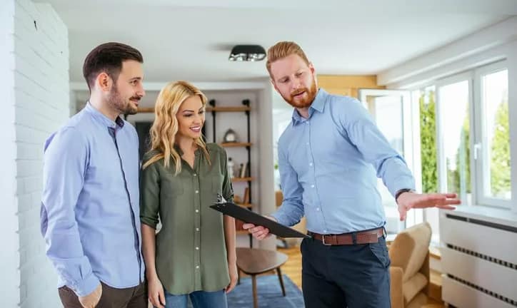 couple looking at house with realtor gSWpKA.width .jpg