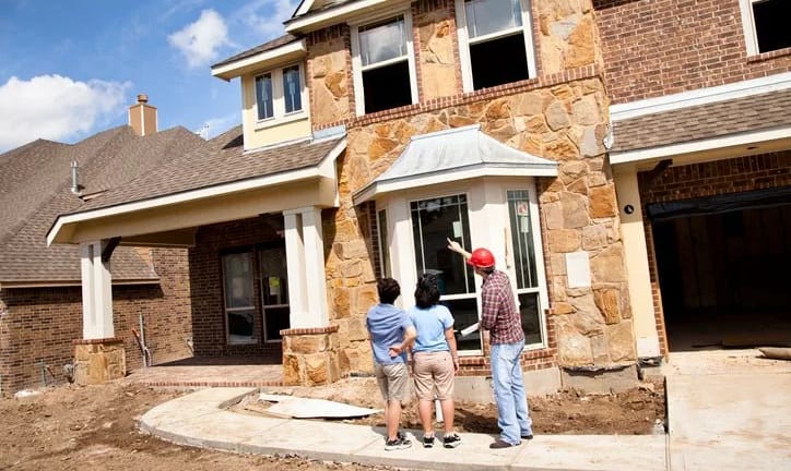 two women and builder at new construction hom.width ozvCZIy.jpg