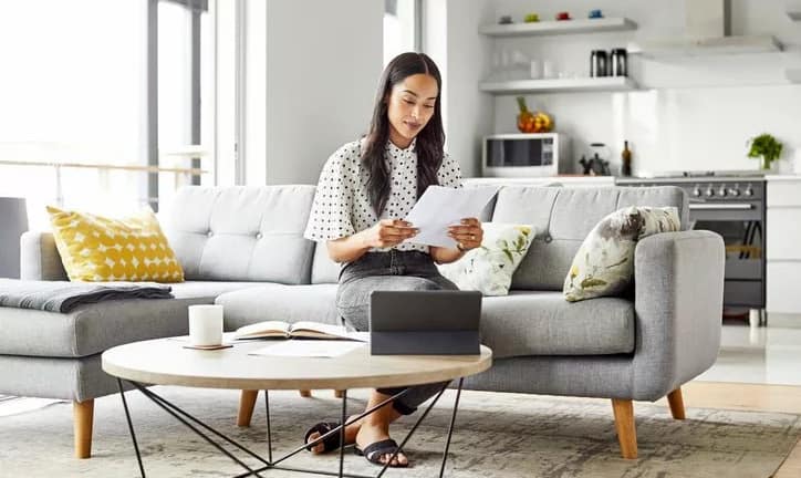 woman on couch with paperwork yVwyVDh.width .jpg