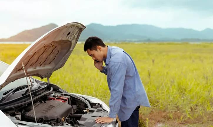 man checking car engine side of road.width .jpg