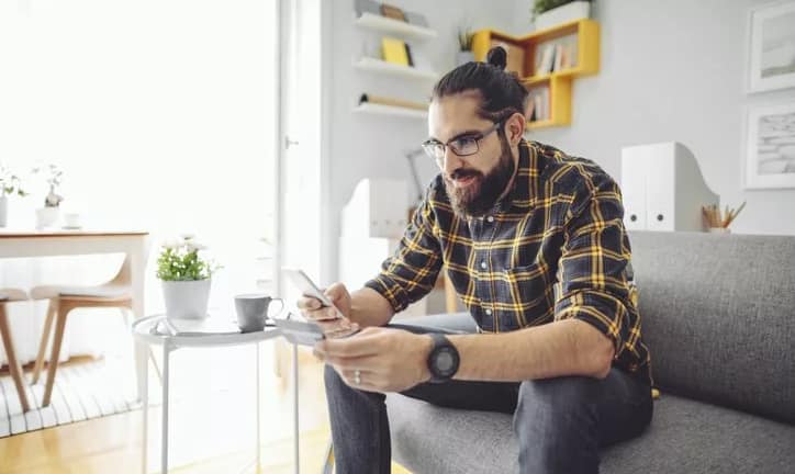 man holding phone and credit card GXOd.width .jpg