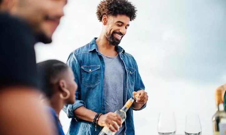 man pouring wine outdoor table Zkcwow.width .jpg