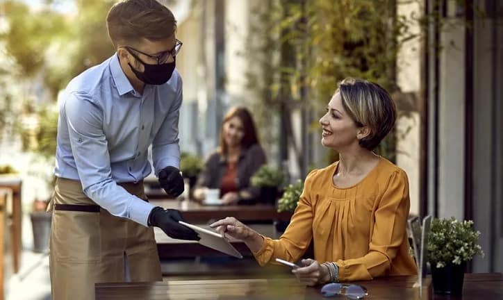 waiter and woman at restaurant.width .jpg