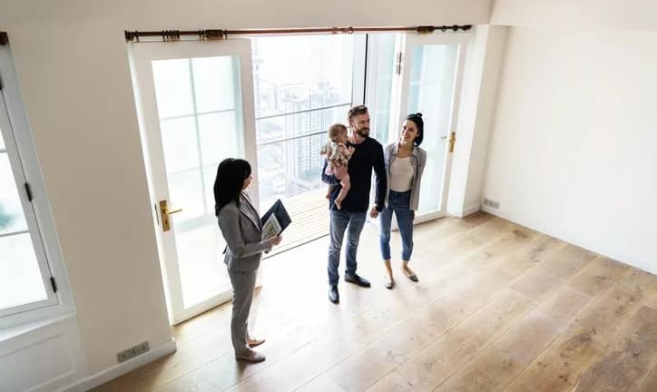 family viewing new house with realtor.width .jpg