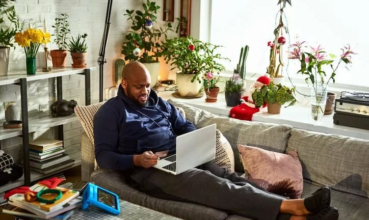 man on couch with laptop and credit card wnWu.width .jpg