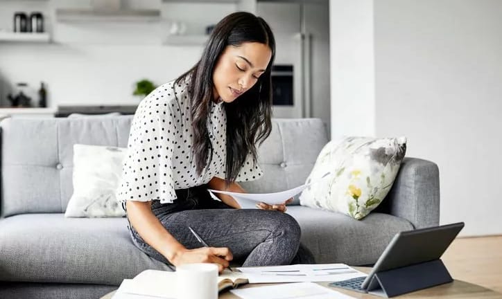 woman on couch with papers and tablet hBtEvpP.width .jpg
