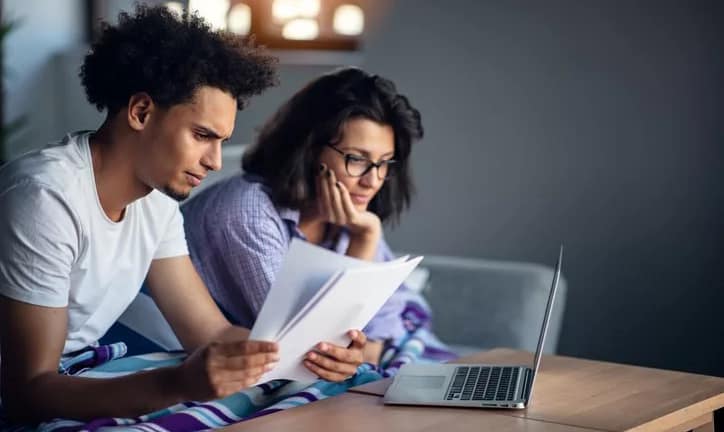 worried couple with bills and laptop.width .jpg