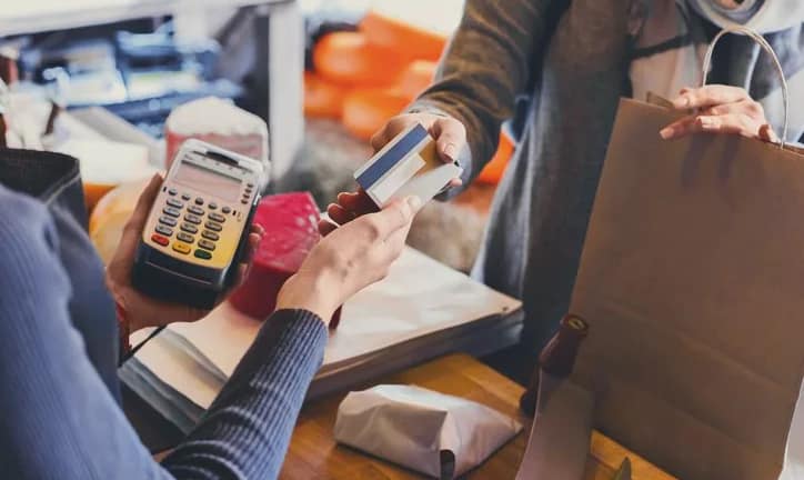 handing credit card to shop cashier.width .jpg