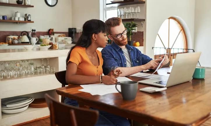 couple reviewing bills on laptop.width .jpg