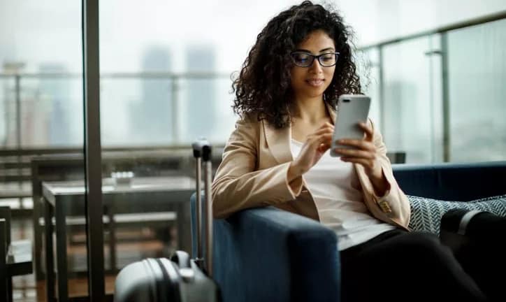 woman with suitcase and phone lalcl.width .jpg
