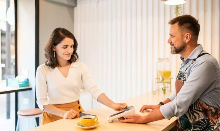 woman paying with credit card cafe BImCnBL.width .jpg