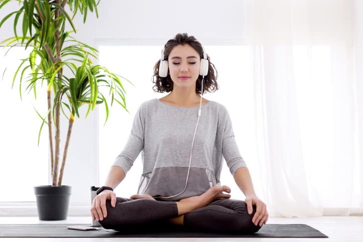 woman doing yoga with headphones.width .jpg
