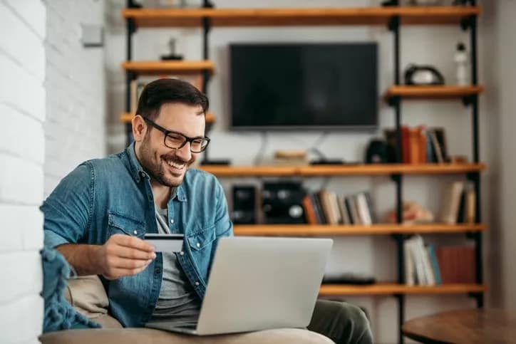man with credit card and laptop.width .jpg