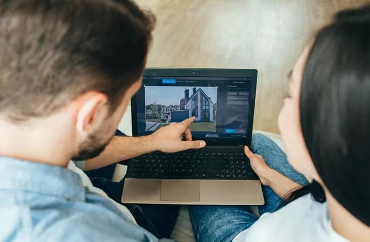 couple looking at house on laptop.width .jpg