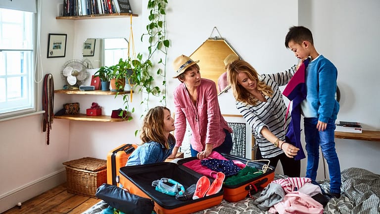 Family with kids packing for vacation qbaFuUl.width
