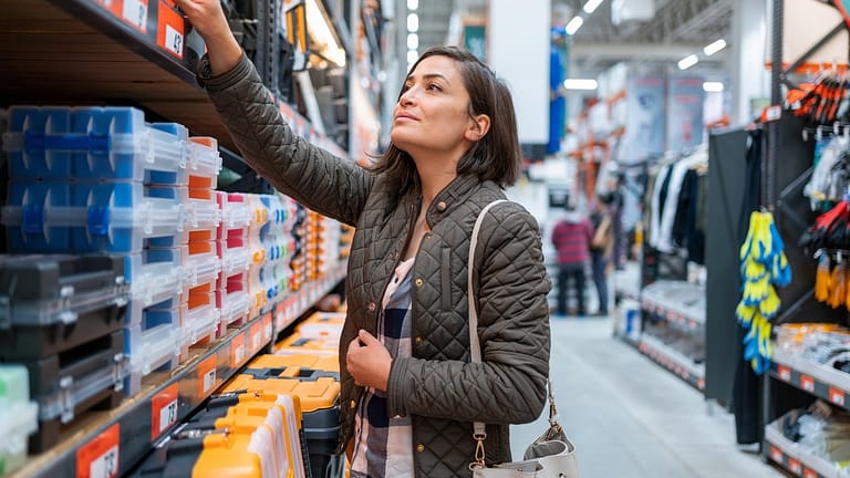 Shopper inspecting items in home improvement .width