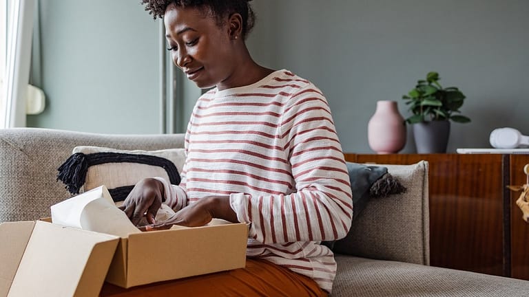 Woman packing up box to return item. juBzvHy.width