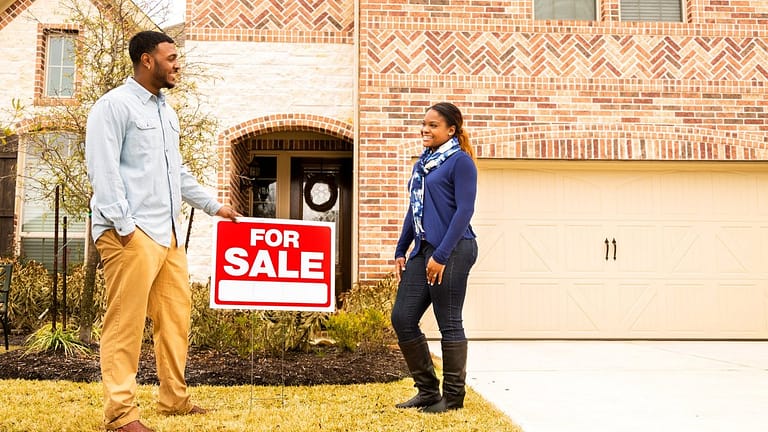 two people in front of house for sale PvidXF.width