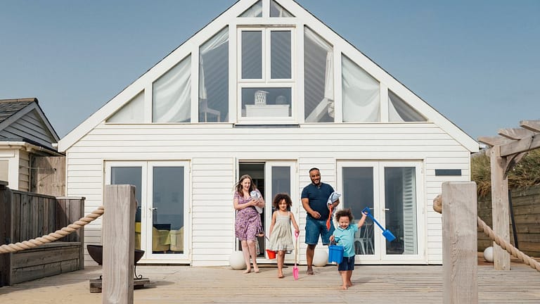 Family emerging from a beach house wvTXk.width .jpg