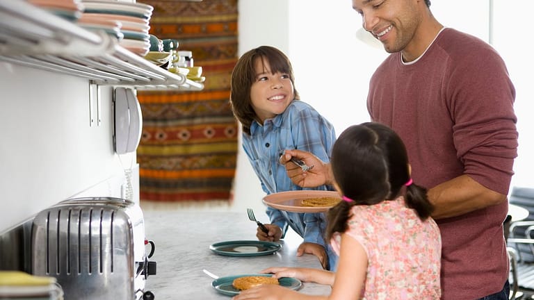Father in kitchen with kids making breakfast .width .jpg